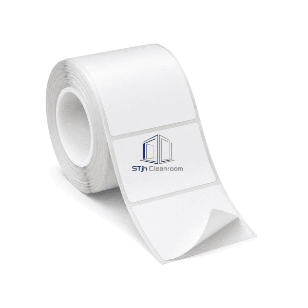 Complete cleanroom label roll with one label corner lifted from the clear PET liner