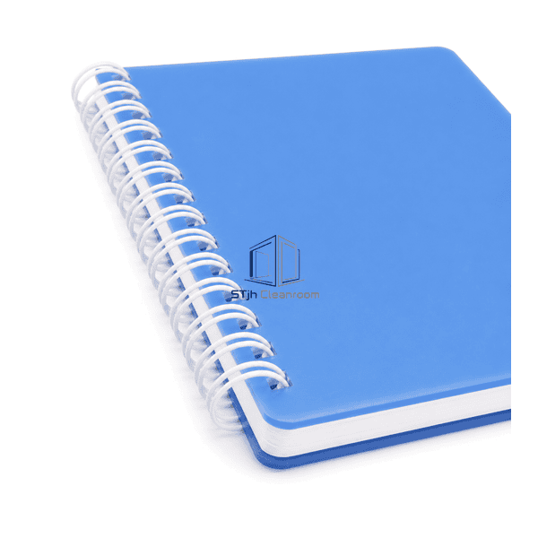Close view of the cleanroom notebook's white spiral, blue cover edge and low-particle page block