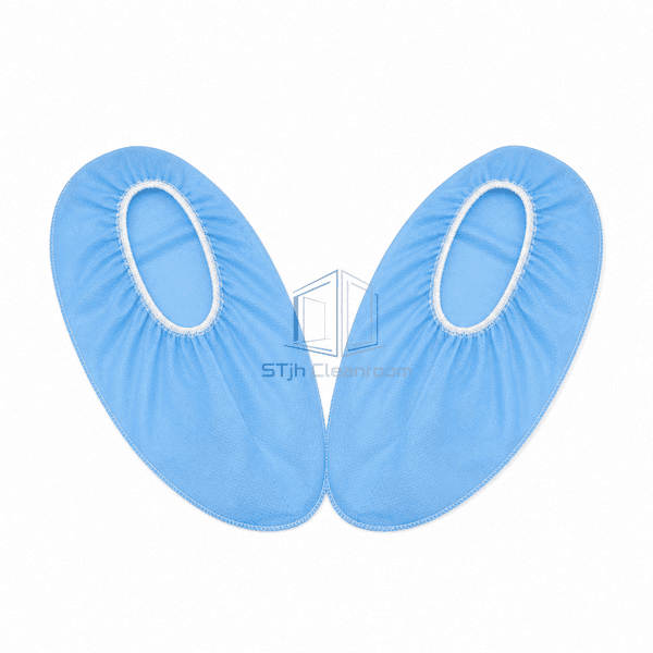 Blue polypropylene shoe covers laid flat as a matched pair