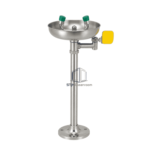 Front view of the emergency eyewash showing the safety-green push flag and balanced nozzle heads